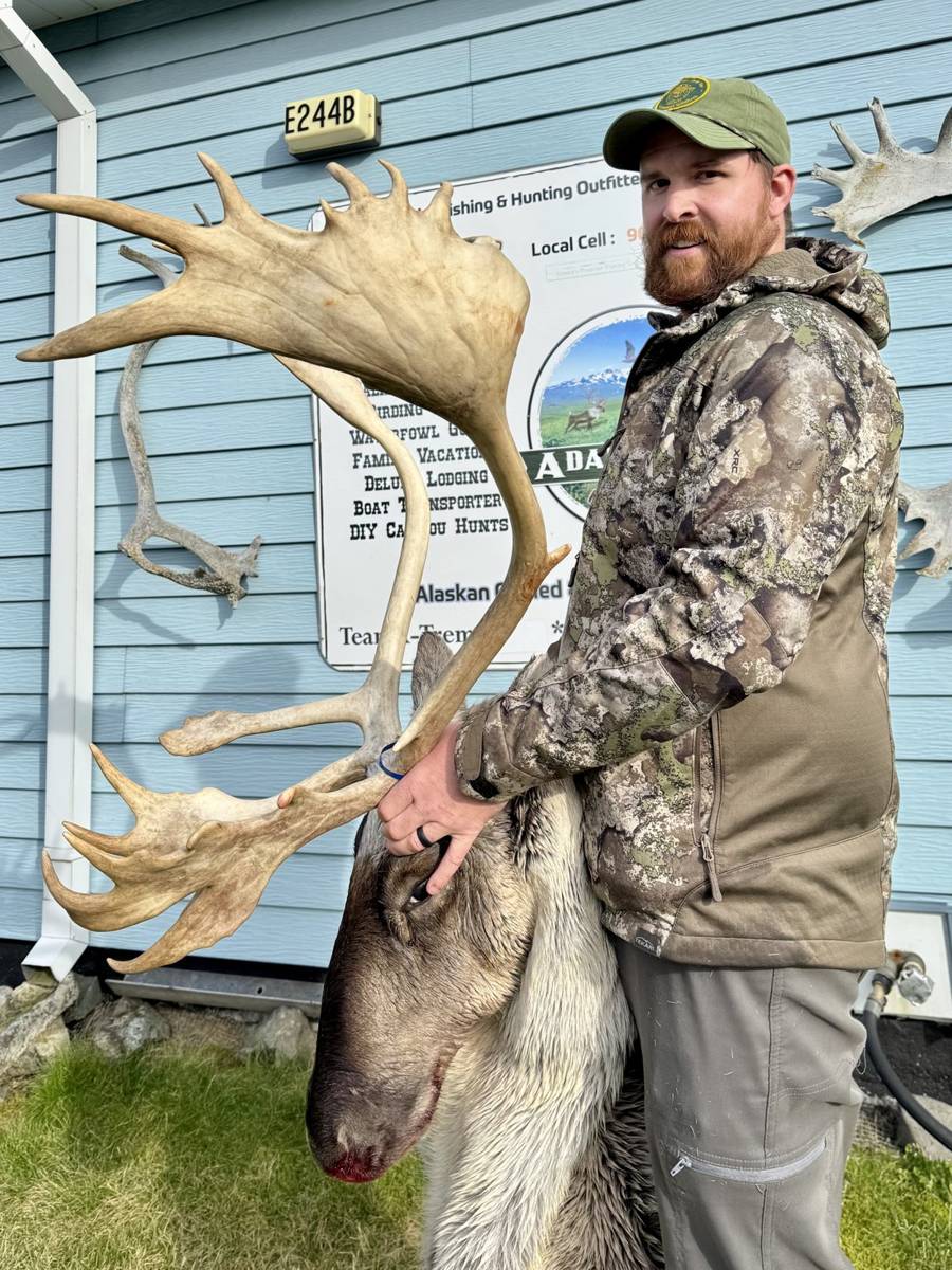 Hunter with massive Barren Ground Caribou rack at the lodge