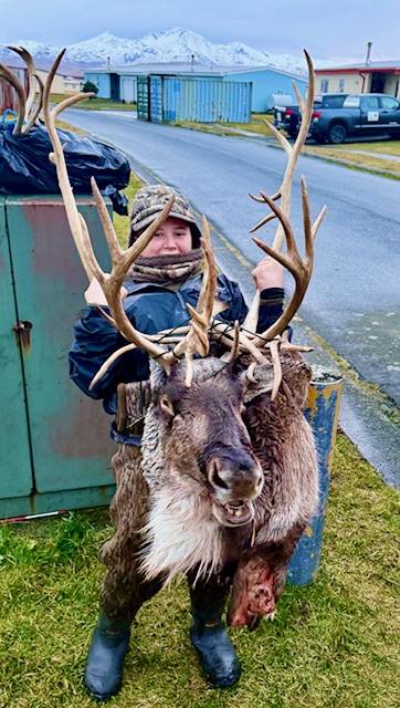Hunter with big Caribou rack on Adak